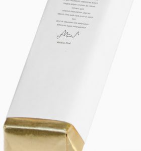 A white box with gold foil on top of it.