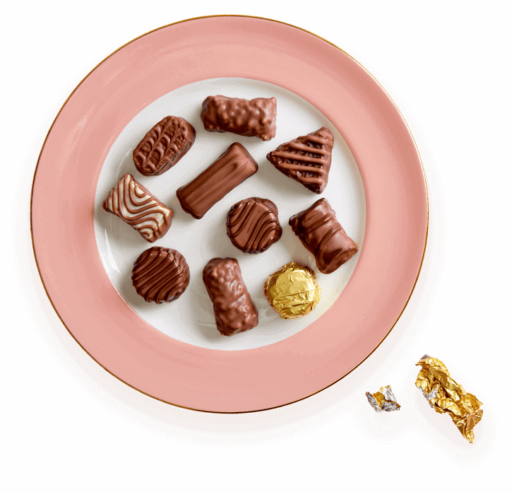 A plate of chocolate covered cookies and candy.