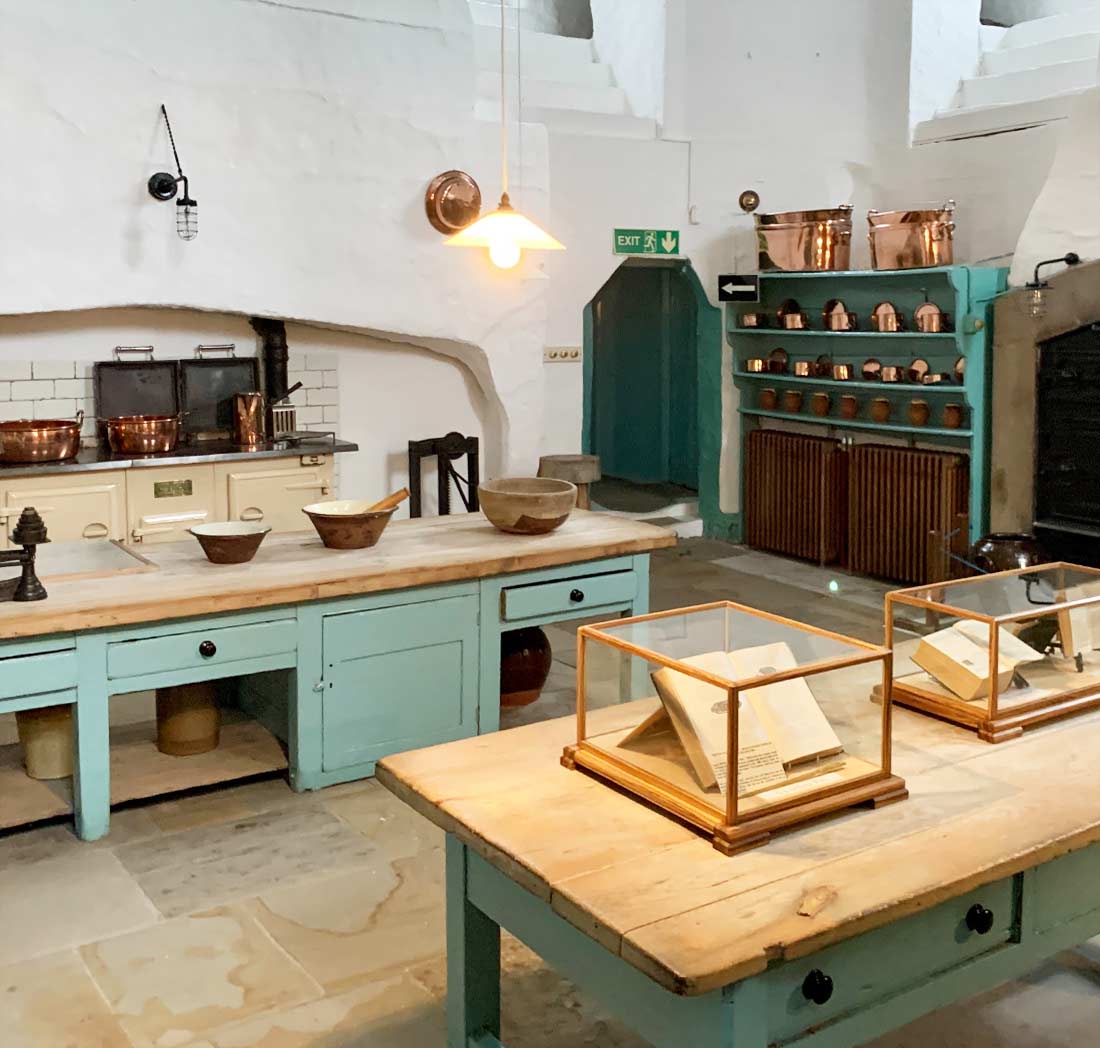 A kitchen with many tables and cabinets in it
