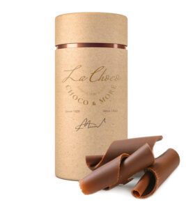 Chocolate curls beside a decorative container.