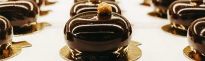 A close up of some chocolate cakes on a plate