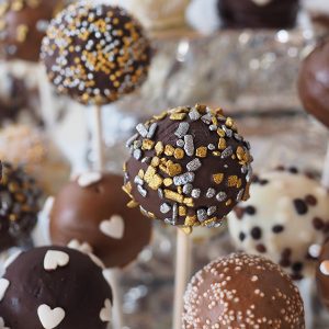 A bunch of cake pops are on the table