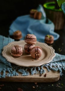 A plate with some chocolate covered cookies on it