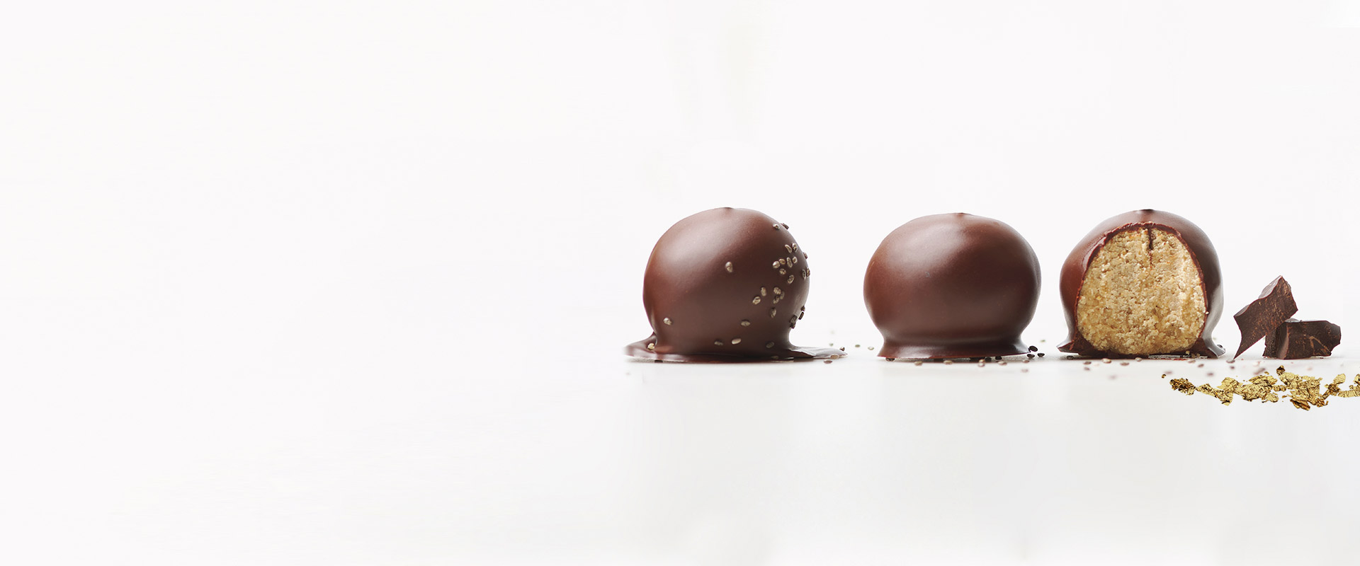 Two chocolate balls with sprinkles on top of them.