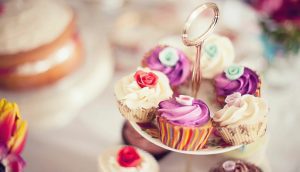 A cake stand with several cupcakes on it.