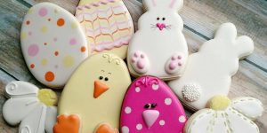 A bunch of decorated cookies that are sitting on the floor