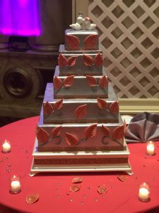 A square cake with red leaves on it