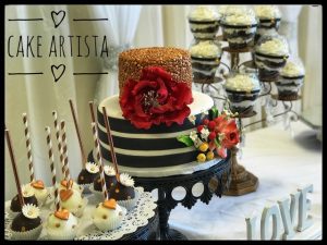 A cake with a big red flower on top of it
