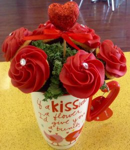 A bouquet of red roses in a mug.
