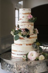 A wedding cake with flowers on top of it.