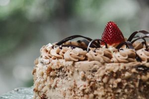 A close up of a cake with strawberries on top