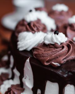 A close up of some chocolate cake with white frosting