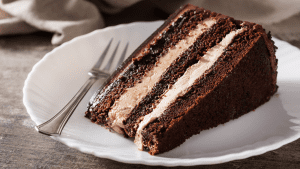 A piece of cake on top of a white plate.