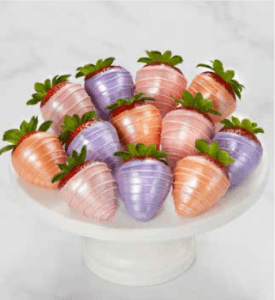 A white plate topped with purple and orange strawberries.
