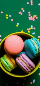 A bowl of colorful macaroons on the table