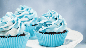 A close up of some blue cupcakes on a table