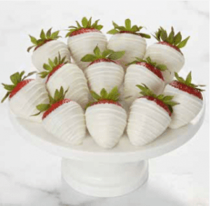 A white plate with strawberries on top of it.