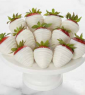 A white plate with strawberries on top of it.