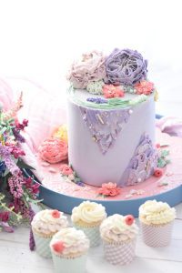 A cake with purple flowers on top of it