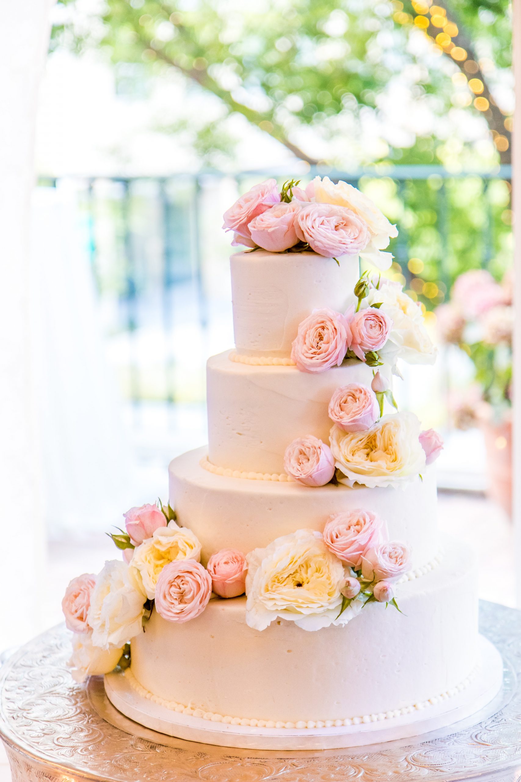 A wedding cake with pink flowers on it