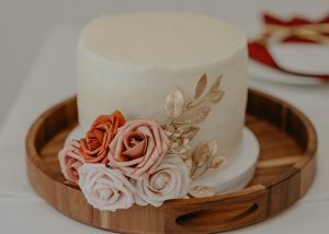 A white cake with flowers on top of it.