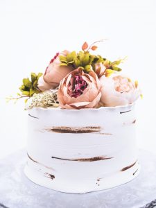 A white cake with flowers on top of it.