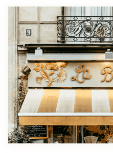 A shop with a gold leaf sign on the front.