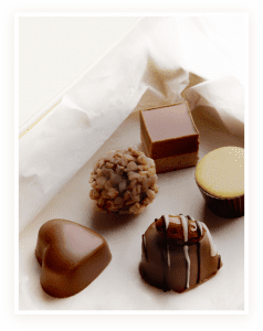 A variety of chocolates are on the table.