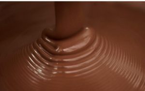 A close up of chocolate being poured into a bowl