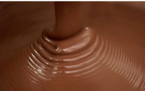A close up of chocolate being poured into a bowl