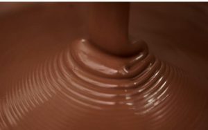A close up of chocolate being poured into the air
