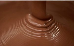 A close up of chocolate being poured into a bowl